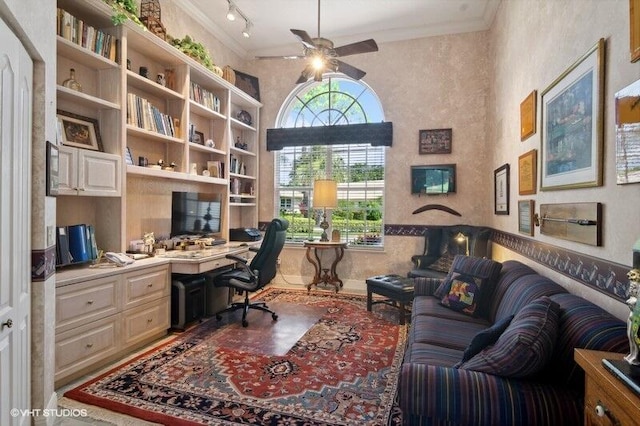 office space with ceiling fan, ornamental molding, track lighting, and built in desk