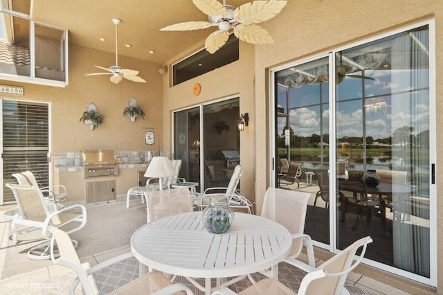 view of patio / terrace with ceiling fan, exterior kitchen, and grilling area