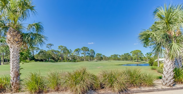 view of home's community featuring a lawn and a water view