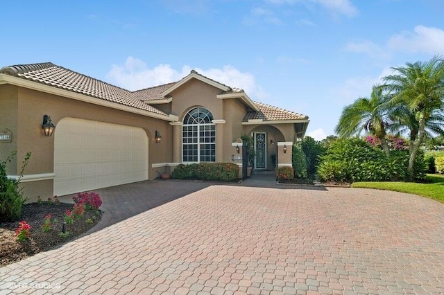 mediterranean / spanish-style house with a garage