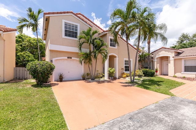 mediterranean / spanish-style home with a front yard and a garage