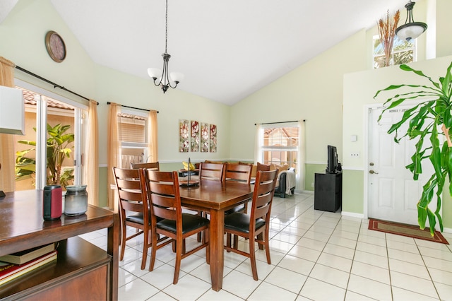 tiled dining space featuring high vaulted ceiling, a chandelier, and plenty of natural light