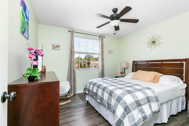 bedroom with ceiling fan and dark wood-type flooring