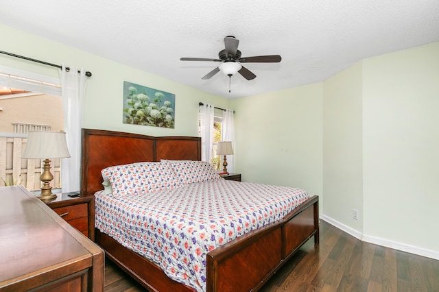 bedroom featuring ceiling fan, dark hardwood / wood-style flooring, and a textured ceiling