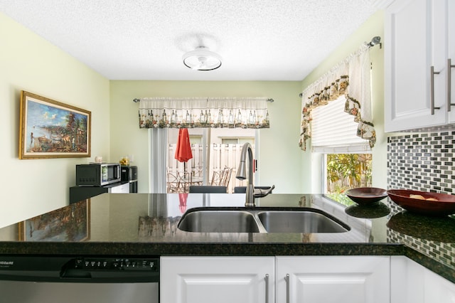 kitchen with a textured ceiling, white cabinets, backsplash, stainless steel appliances, and sink