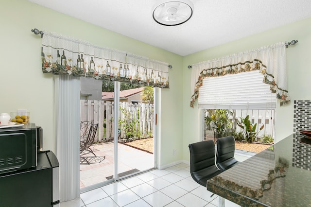 doorway to outside featuring light tile patterned flooring