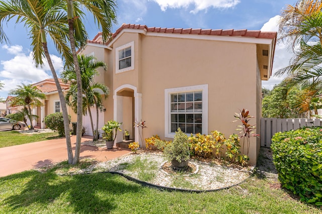 mediterranean / spanish-style home featuring a front lawn