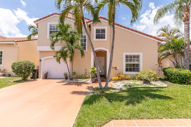 mediterranean / spanish home featuring a front lawn and a garage