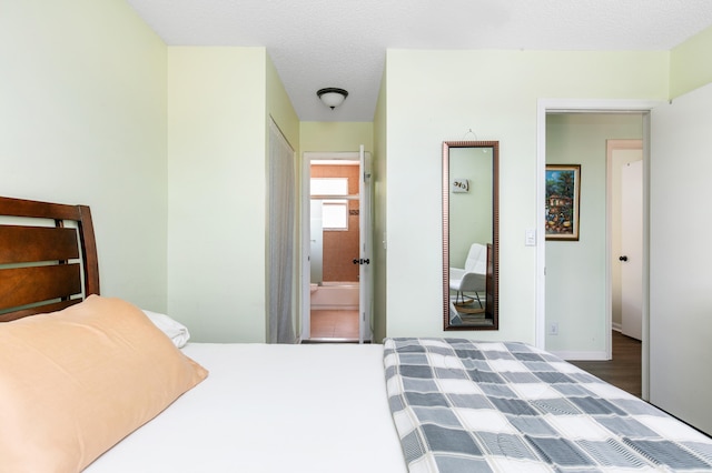 bedroom with a textured ceiling and hardwood / wood-style flooring