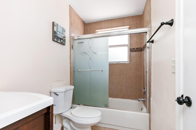 full bathroom featuring vanity, bath / shower combo with glass door, and toilet