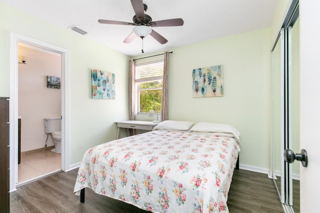 bedroom with dark hardwood / wood-style floors, a closet, ceiling fan, and ensuite bathroom