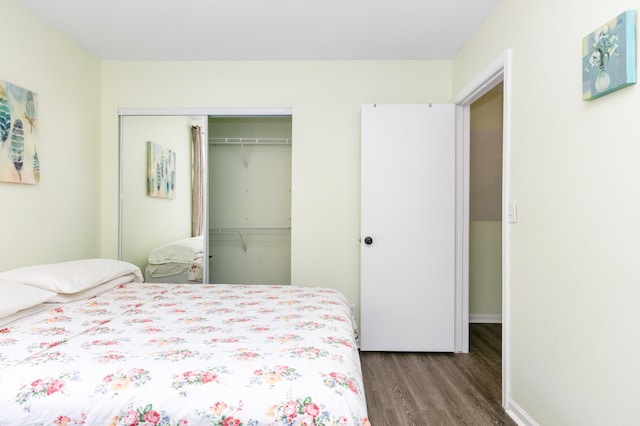 bedroom with hardwood / wood-style floors and a closet