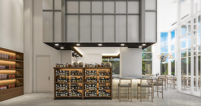 bar featuring concrete floors and wall chimney exhaust hood