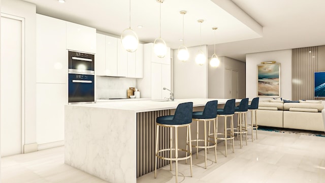 kitchen with white cabinets, hanging light fixtures, a kitchen island with sink, and light tile patterned floors