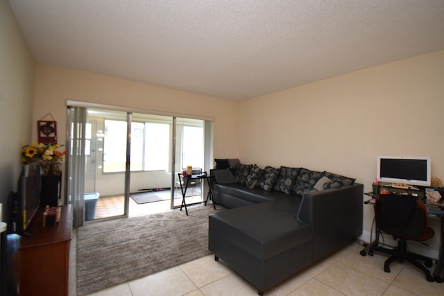 living room with light tile patterned floors and a textured ceiling