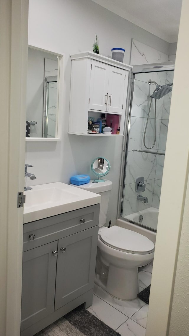 full bathroom with enclosed tub / shower combo, vanity, tile patterned flooring, and toilet