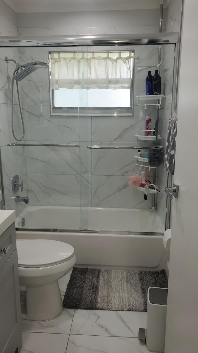 full bathroom with toilet, vanity, a wealth of natural light, and bath / shower combo with glass door