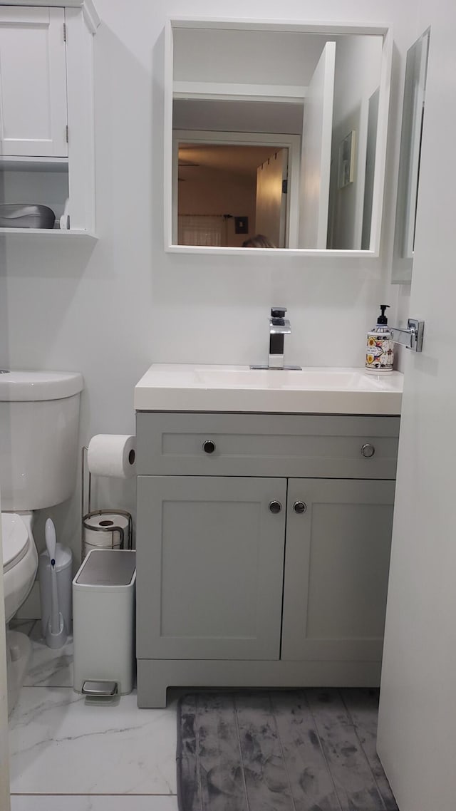 bathroom with tile patterned floors, vanity, and toilet