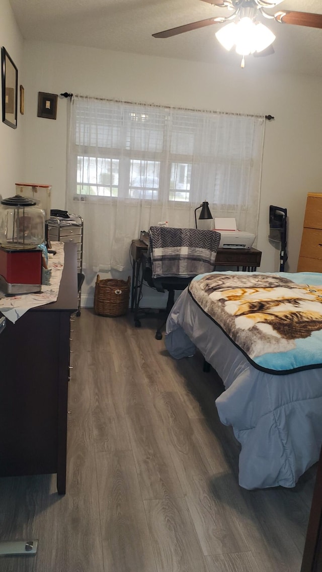 bedroom featuring hardwood / wood-style floors and ceiling fan