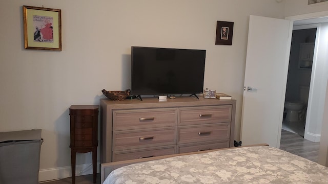 bedroom featuring dark hardwood / wood-style flooring