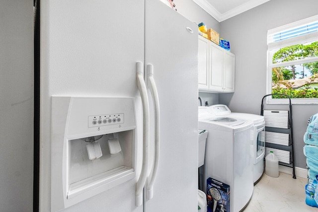 washroom with separate washer and dryer, crown molding, and cabinets