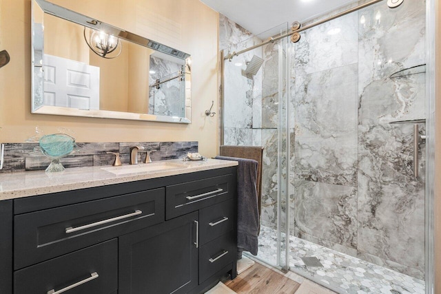 bathroom featuring a shower with door, hardwood / wood-style flooring, and vanity