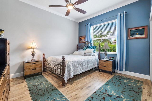 bedroom featuring ornamental molding, light hardwood / wood-style flooring, and ceiling fan