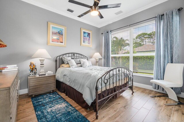 bedroom with ceiling fan, crown molding, and light hardwood / wood-style flooring