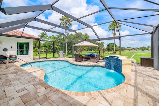 view of swimming pool featuring glass enclosure, pool water feature, a yard, and a patio area