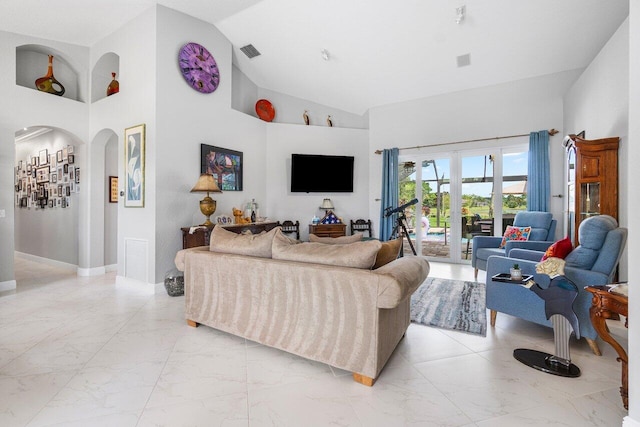 living room featuring high vaulted ceiling and french doors