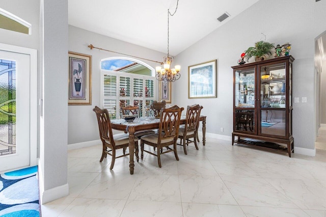 dining area featuring lofted ceiling and an inviting chandelier