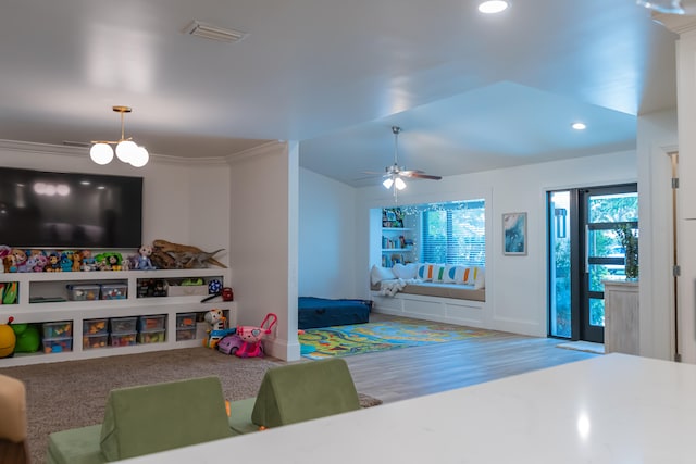 game room featuring ceiling fan and built in shelves