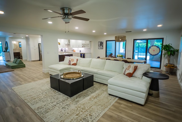 living room featuring hardwood / wood-style floors and ceiling fan