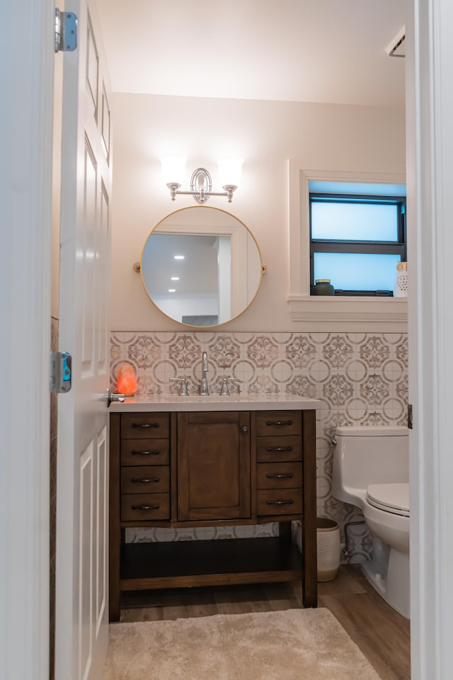 bathroom featuring vanity, toilet, and hardwood / wood-style floors