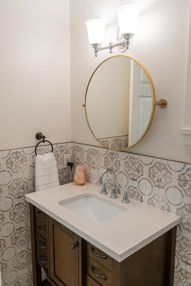 bathroom featuring vanity and tile walls