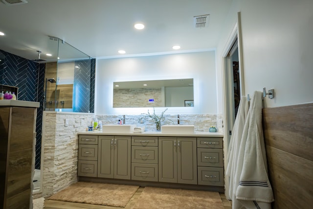 bathroom with vanity, tile walls, and a shower