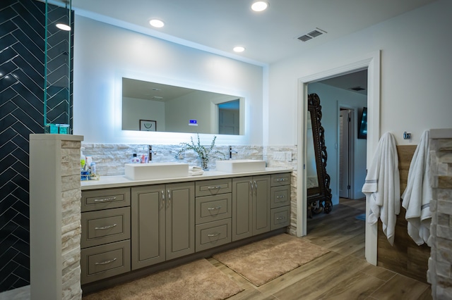 bathroom featuring hardwood / wood-style flooring, vanity, and tile walls