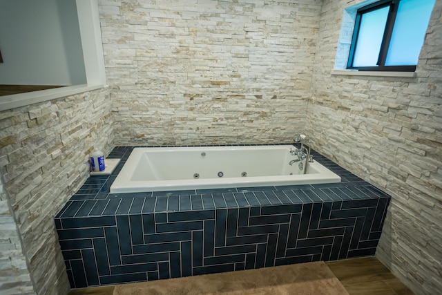 bathroom featuring a relaxing tiled tub