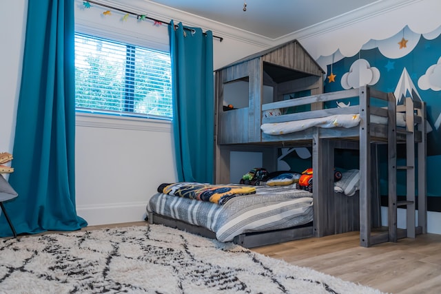 bedroom featuring crown molding and wood-type flooring