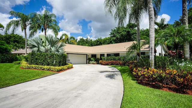 single story home featuring a garage and a front yard