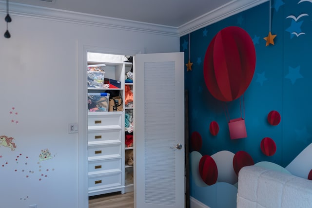 bedroom featuring crown molding and wood-type flooring