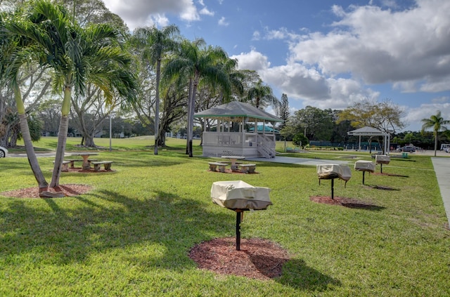 view of property's community with a lawn and a gazebo