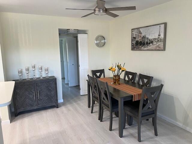 dining room featuring ceiling fan and light hardwood / wood-style flooring