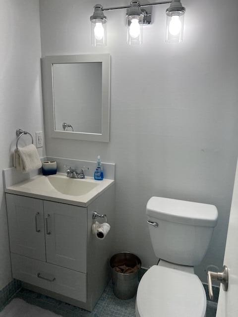 bathroom with toilet and vanity