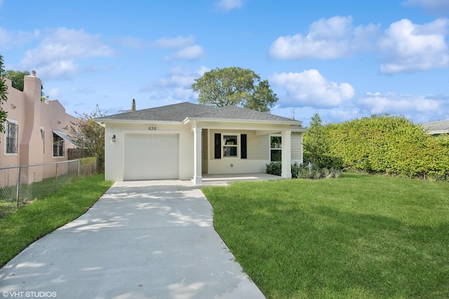 view of front of home with a garage and a front lawn