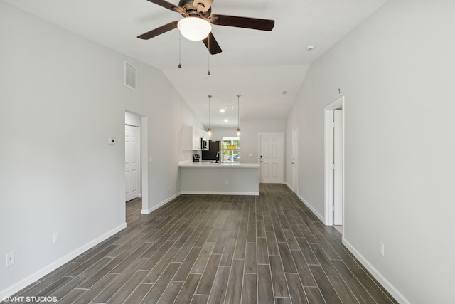 unfurnished living room with ceiling fan, dark hardwood / wood-style flooring, and lofted ceiling