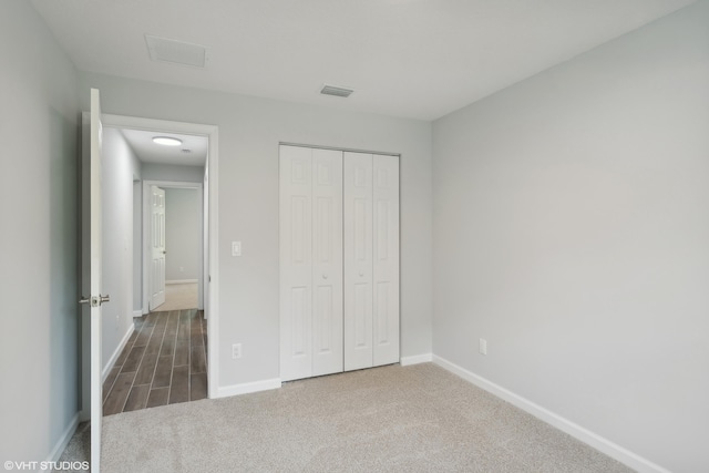 unfurnished bedroom with carpet floors and a closet