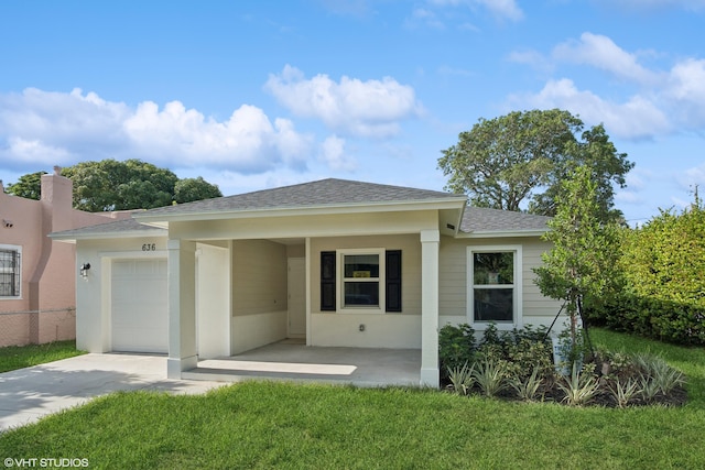 view of front of property featuring a garage and a front lawn