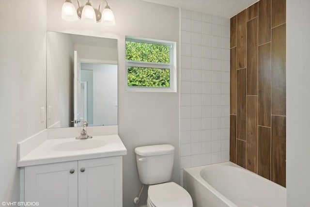 full bathroom with tiled shower / bath combo, toilet, a textured ceiling, and vanity