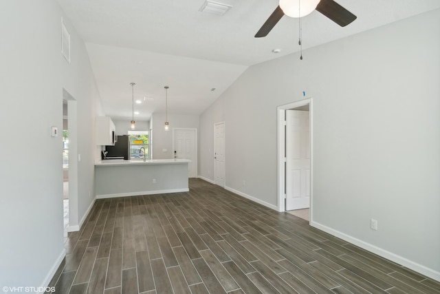 unfurnished living room with hardwood / wood-style flooring, sink, lofted ceiling, and ceiling fan